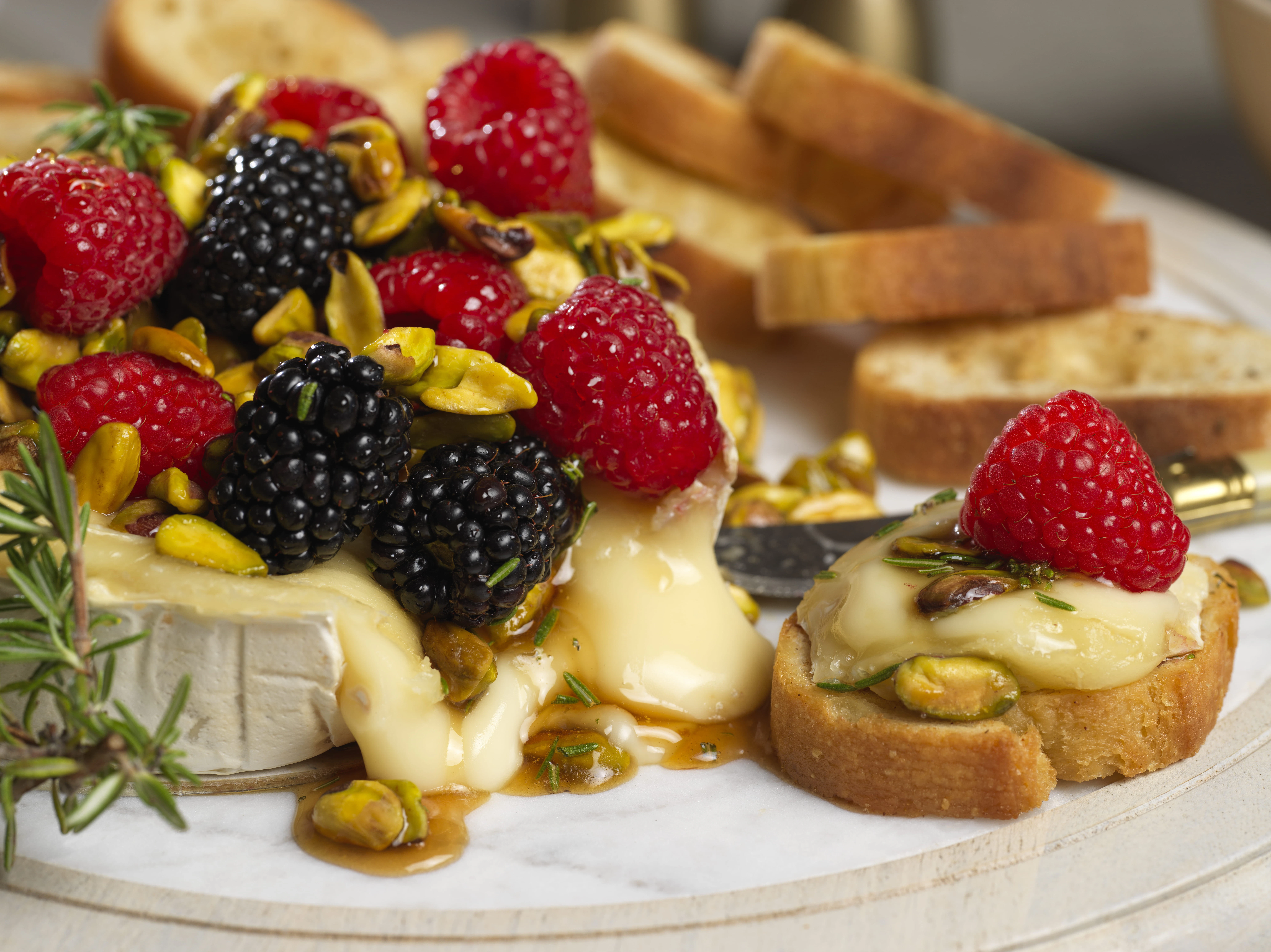 Baked Brie with Honeyed Mixed Berries and Pistachios