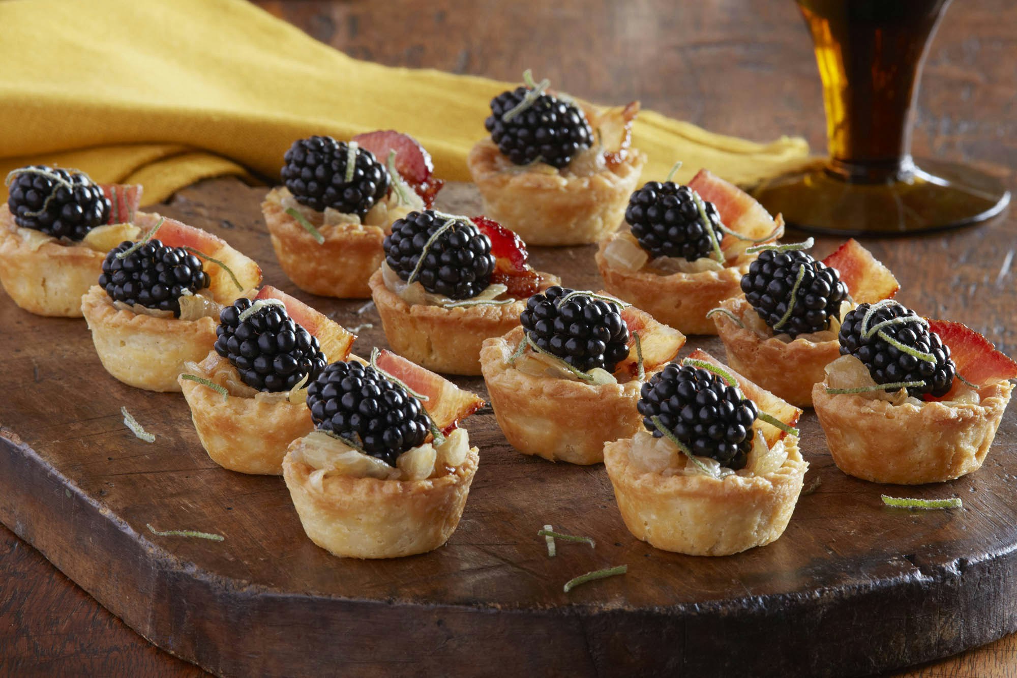 Small blackberry and bacon caramelized onion tartlets