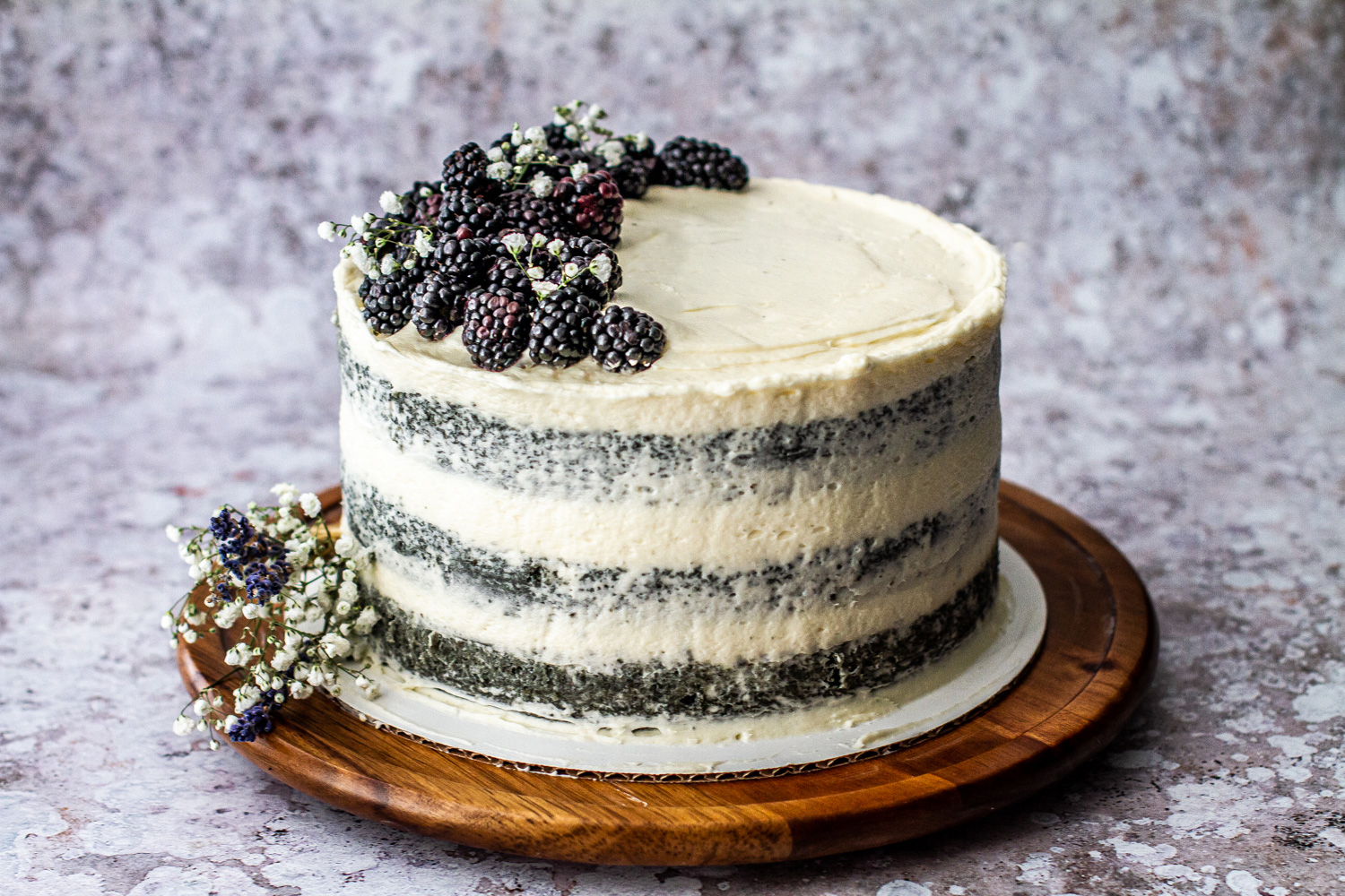 Vanilla bundt cake with blackberry swirls and vanilla glaze