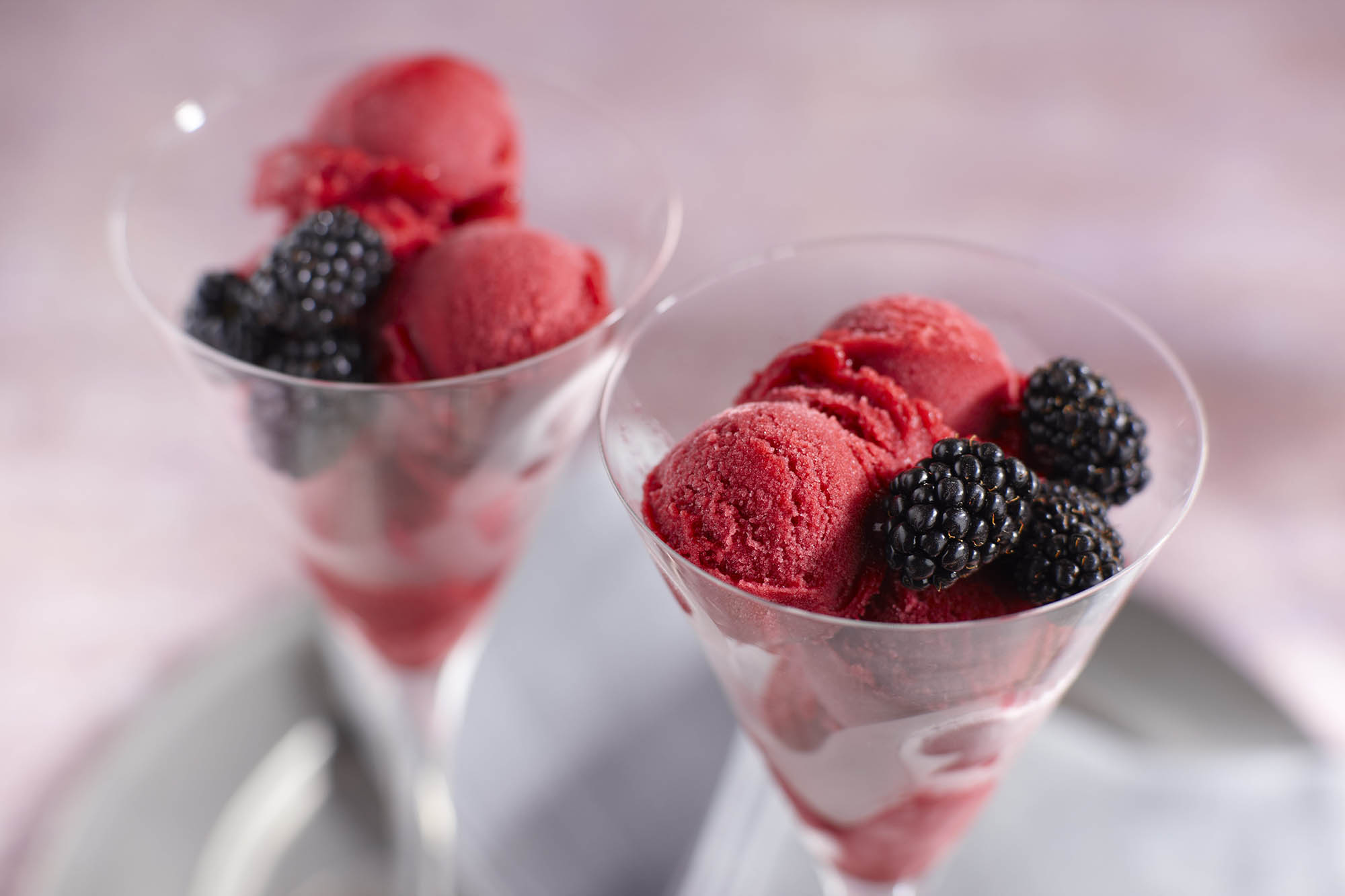 Two glasses with a scoop of blackberry pinot noir sorbet 
