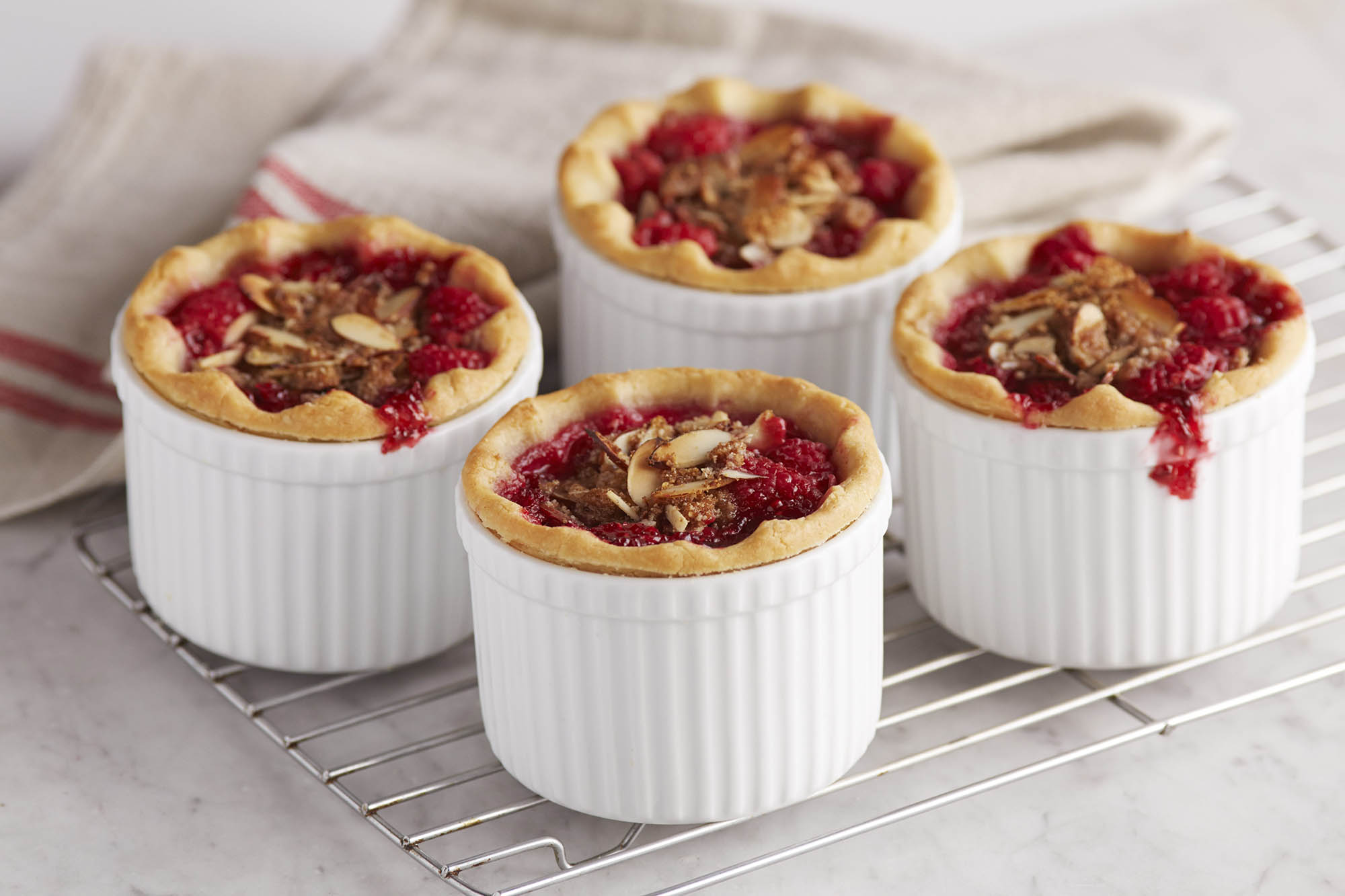 Four gluten free mini raspberry almond pies
