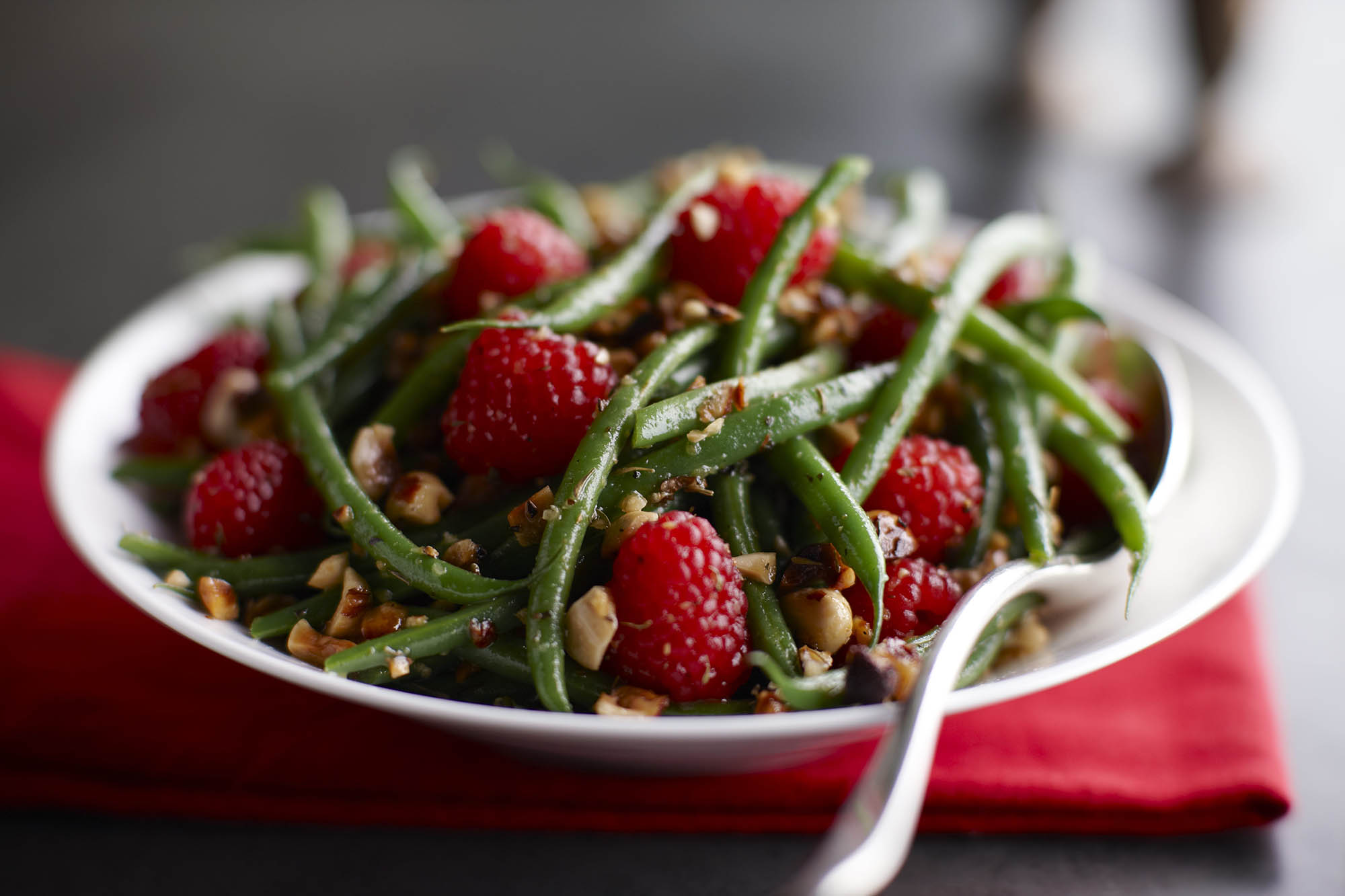 Green bean and raspberry hazelnut toss in a bowl