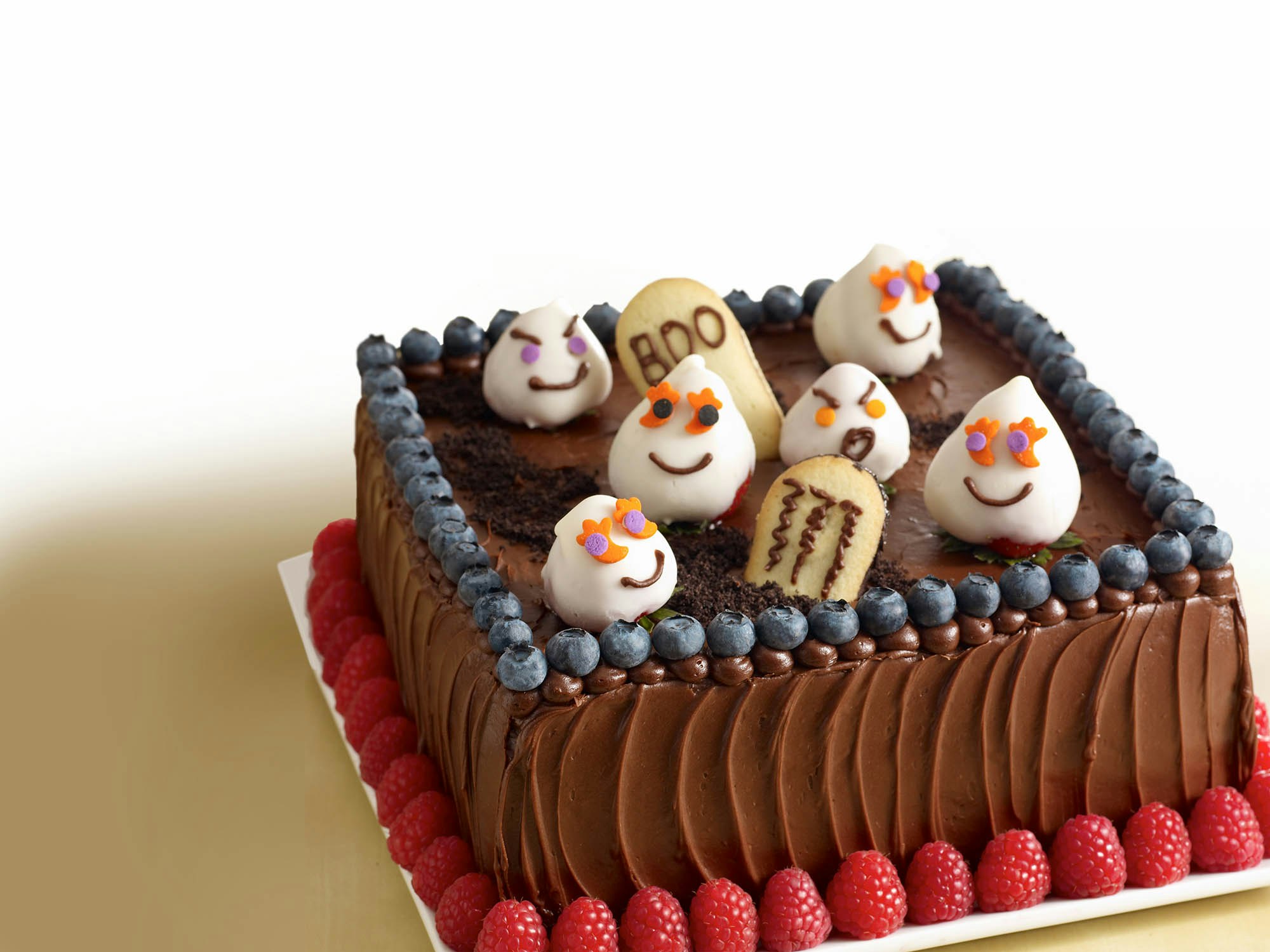 Mixed berry cake decorated to look like a halloween graveyard 