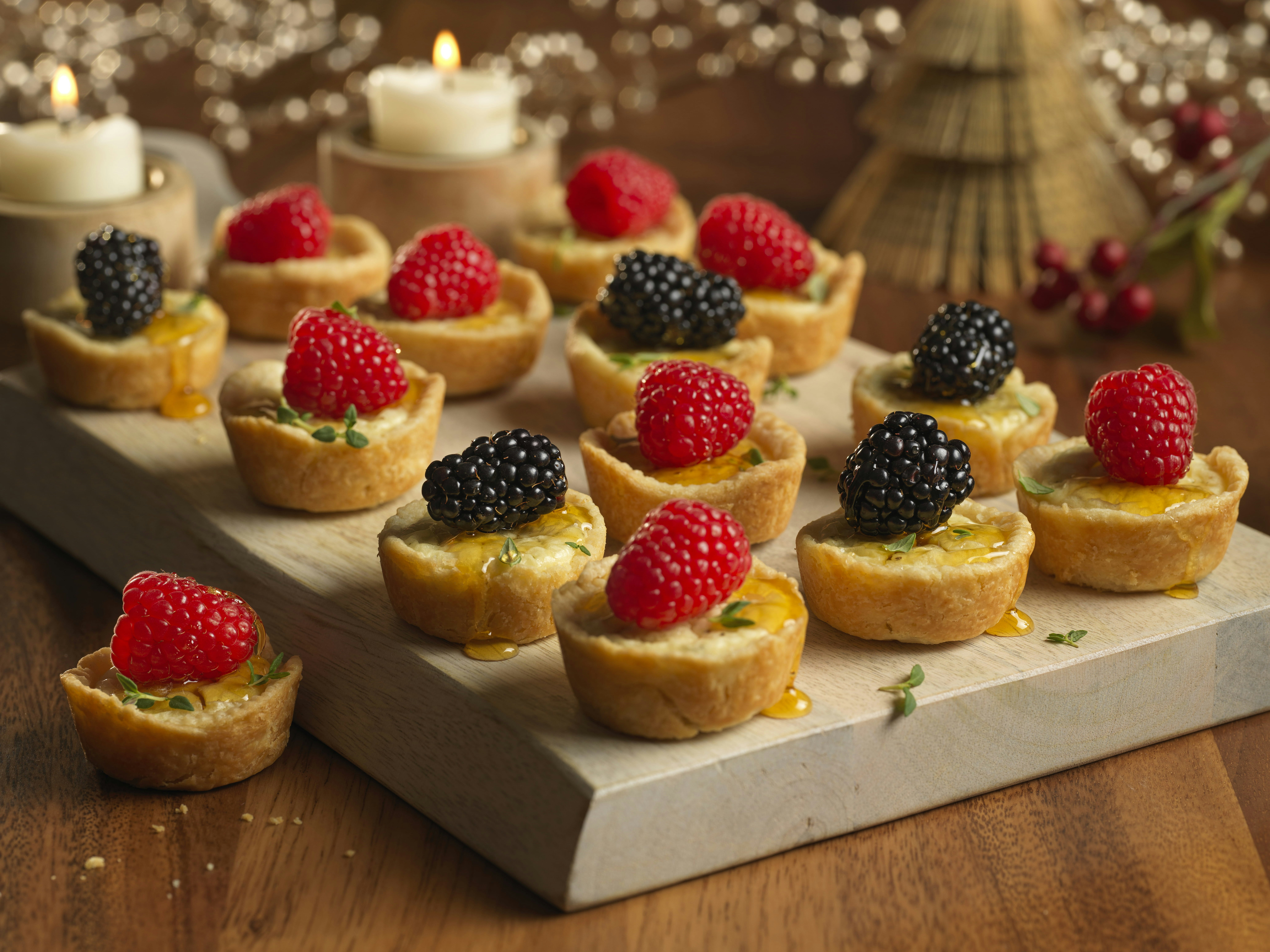 Tray of cheese tartlets with mixed berries 