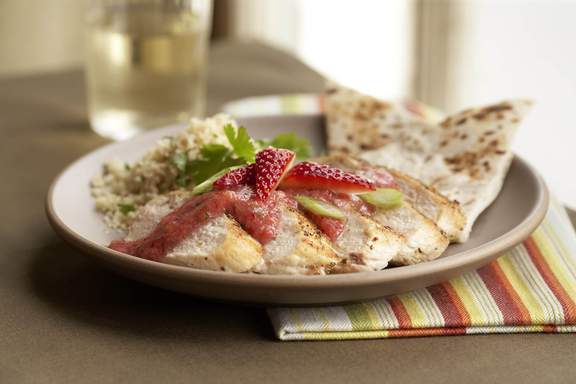 Plate of spicy cumin chicken with strawberry coulis