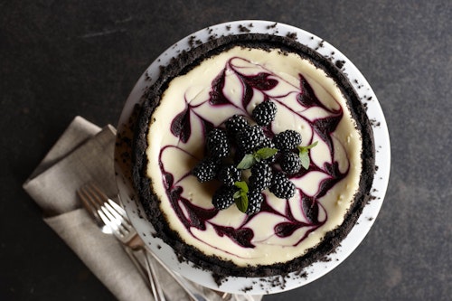 Swirled blackberry cheesecake with blackberries on top